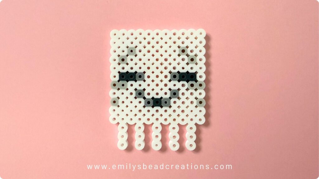 A picture of a perler bead Minecraft Happy Ghastling on a pink background.