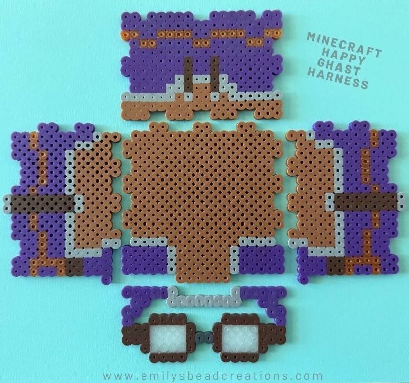 A photo of ironed perler beads in the shape of a happy ghast harness.