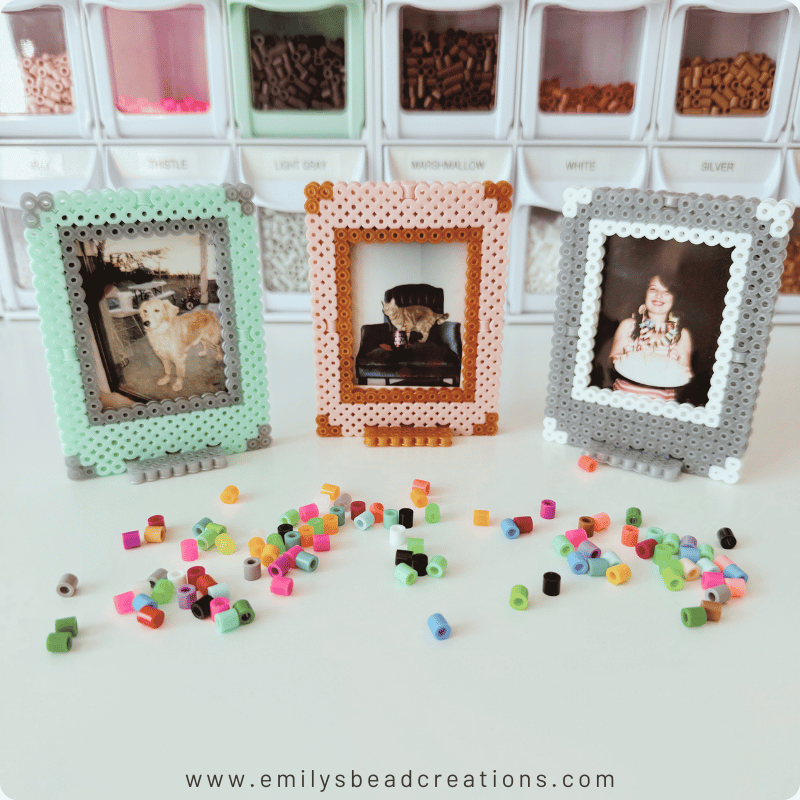 3 instant photo Perler bead frames—mint, rose, and silver—on a white surface with scattered fuse beads.